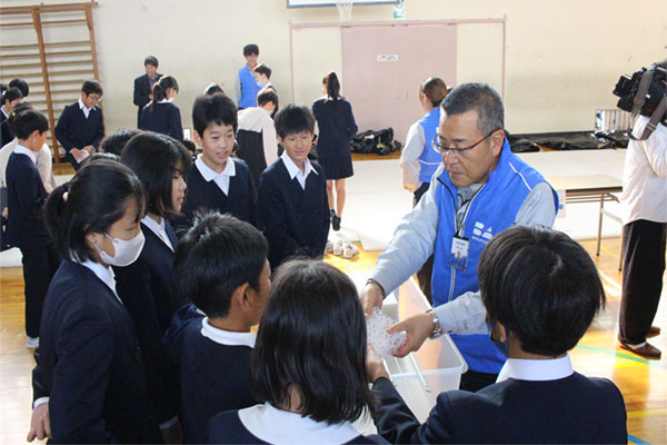 Students testing stain removal performance of different materials