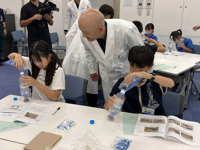 Participants building osmosis experiment devices